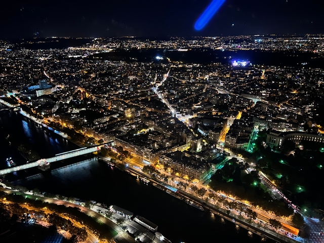       Aerial view of a sprawling cityscape at night.
  