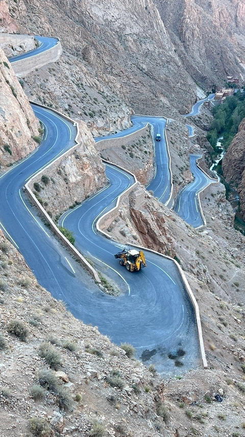       Winding mountain road with a vehicle.
  