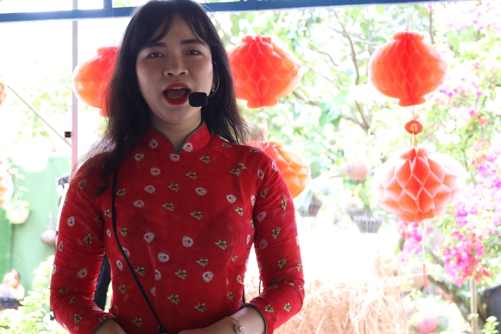 Person in traditional costume with a microphone.