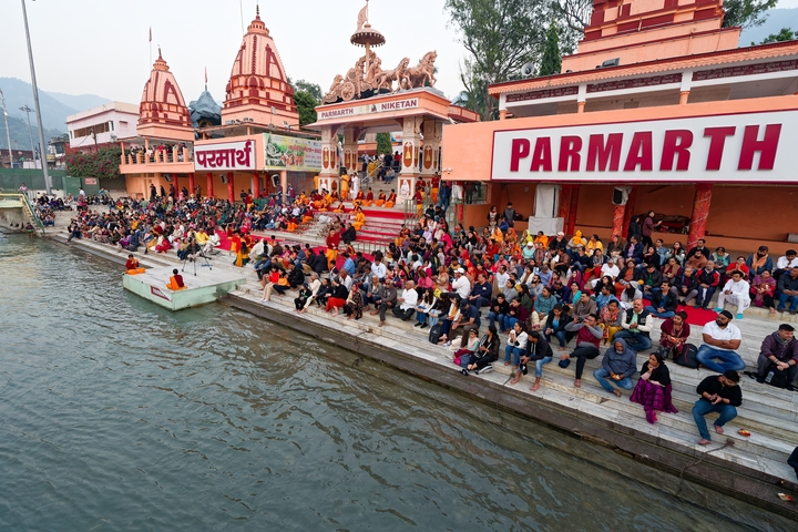 People gathered at Parmath Niketan on the riverbank.