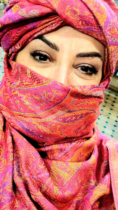       Person with colorful scarf covering face.
  