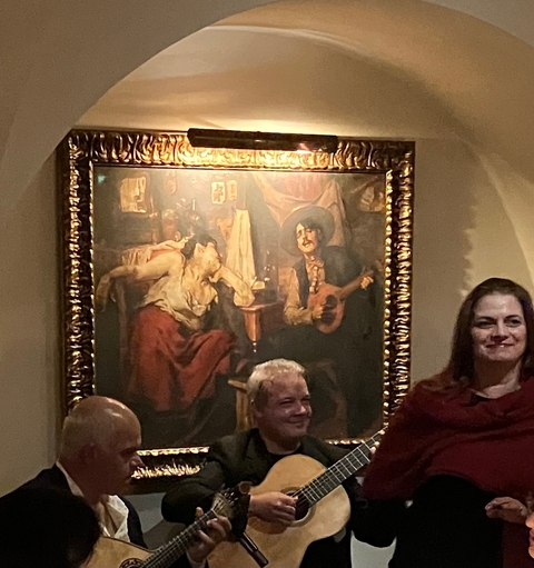 Interior of a restaurant with painting on the wall.