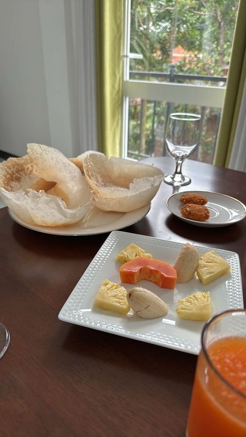       A plate of assorted sweets and fruit.
  