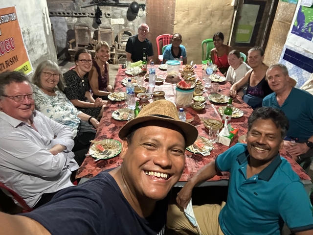 Large group enjoying a meal at a festive table.
