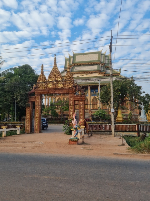      Gate with ornate carvings leading to a temple complex.
  