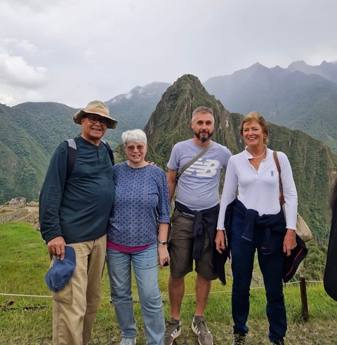 Group posing at Machu Picchu with iconic mountain