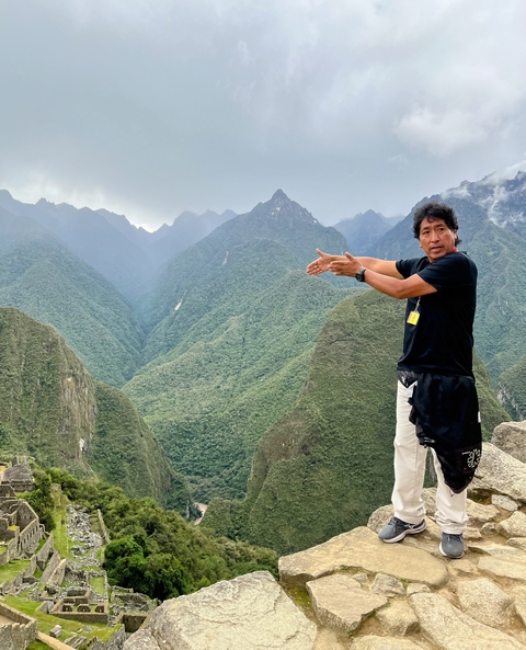 Person pointing at mountains near Machu Picchu