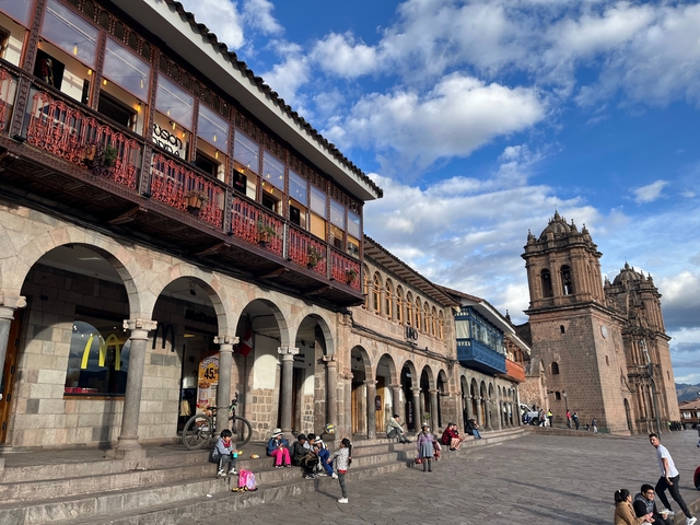 Historic city square with arches and church