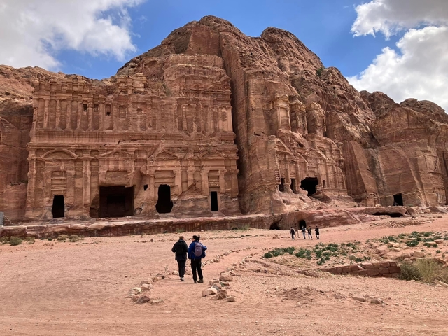       Tourists walking towards Petra's rock-cut architecture
  