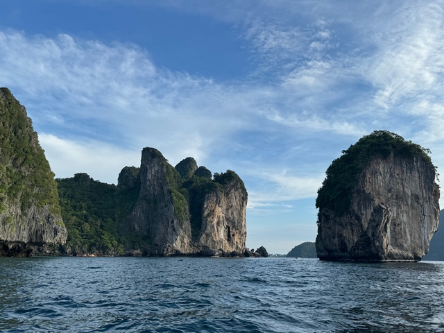 Tall limestone rock formations in a bay.