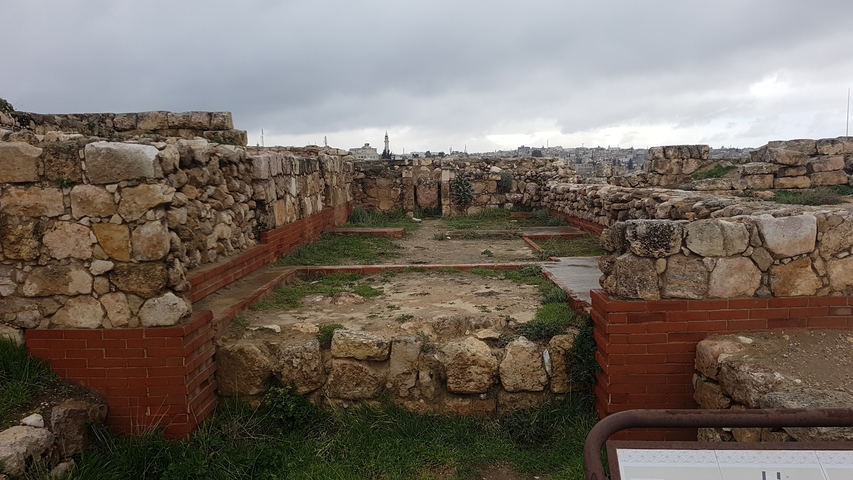       Ancient stone ruins with a cloudy sky in the background.
  