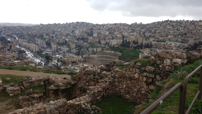       View of a city with ancient ruins in the foreground.
  