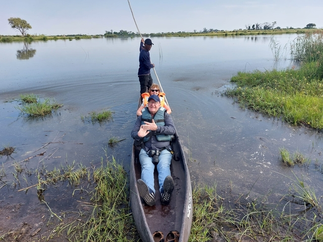 Tourists in a canoe on a waterway.