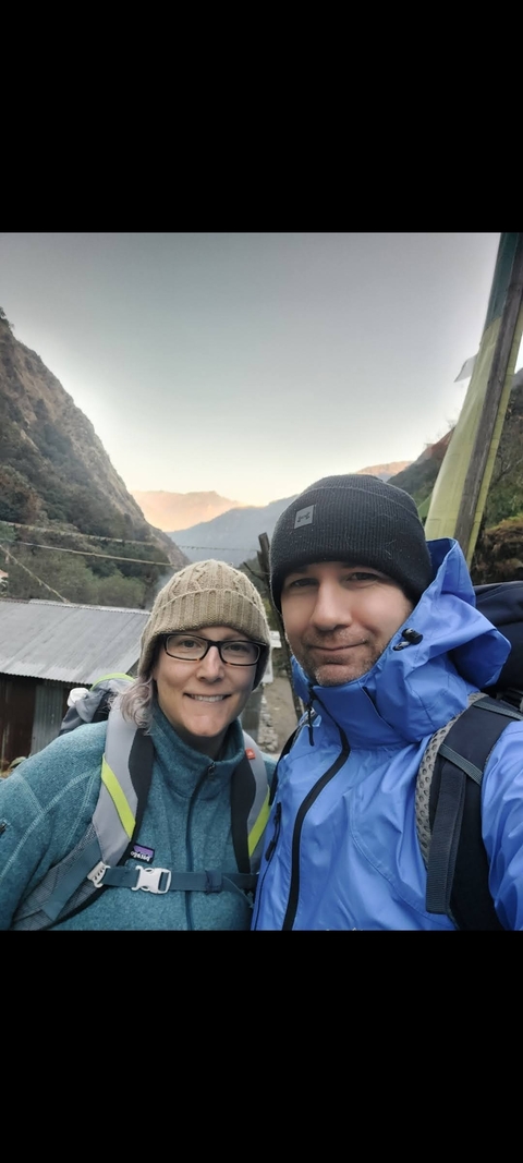 Two hikers in winter clothing in a mountainous area.