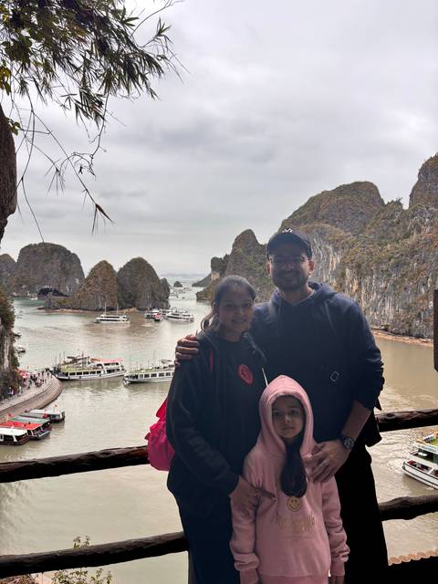       Upside-down image of family posing with a bay view.
  