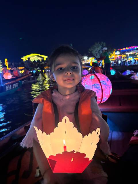       Upside-down image of a child holding a lantern.
  