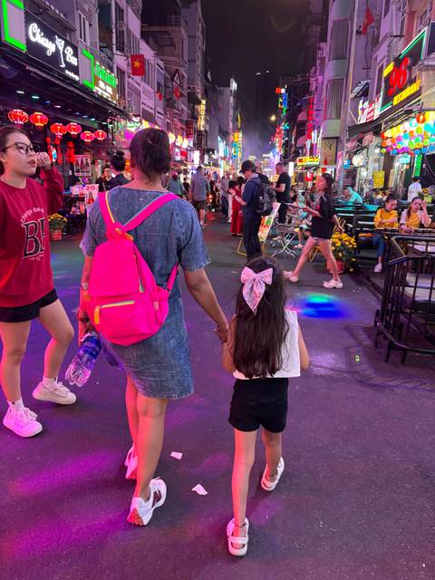       Upside-down image of people walking through a lively night market.
  