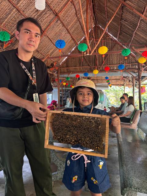 Upside-down image of a child and adult holding a frame.