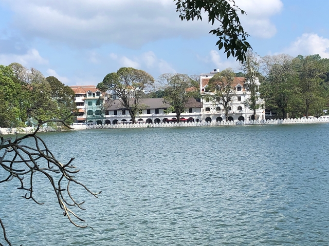       Lakeside view with colonial buildings in the background.
  