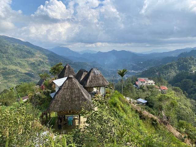 Mountainous landscape with traditional huts.