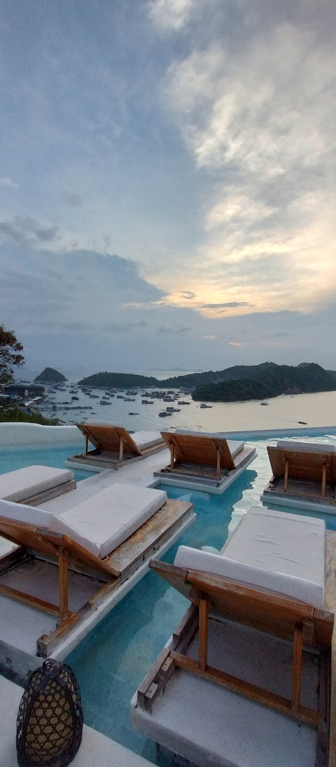 Overlooking a bay with boats at sunset.