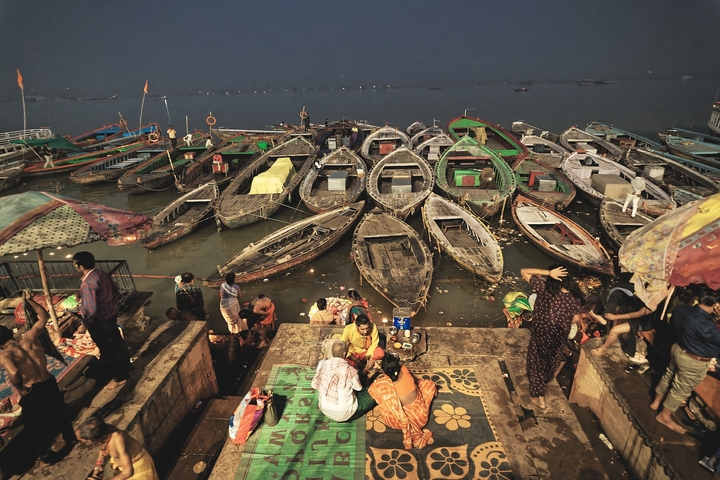       River scene with many boats and people.
  