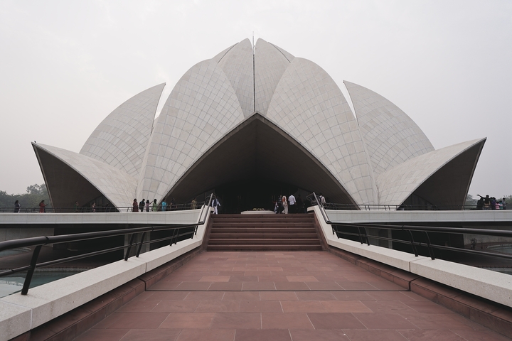       Lotus Temple with visitors on the path.
  