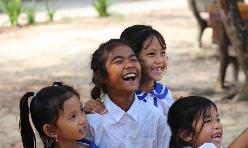 Group of smiling children outdoors.