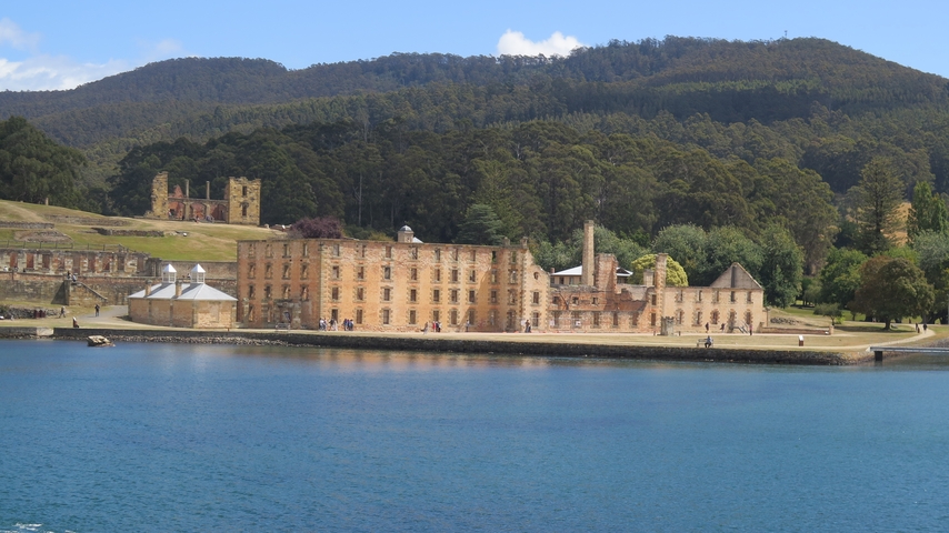 Historic site with a large building by the water.