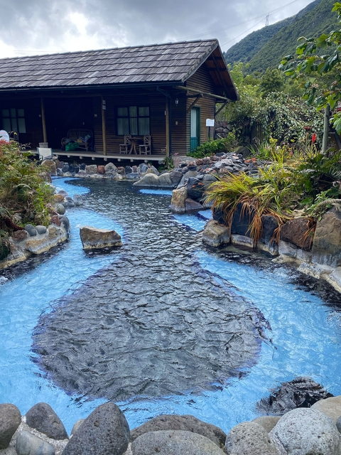 Hot springs with rocky surroundings and plants.