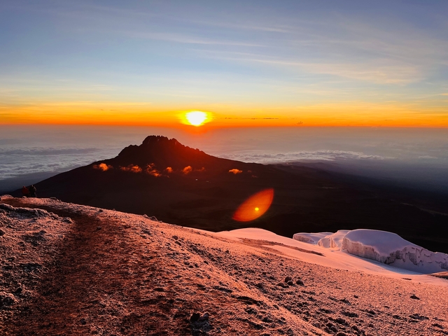 Mountains with snow and a vibrant sunset.