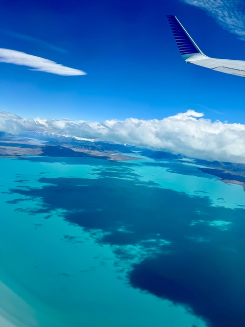 Aerial view of a lake with clouds and mountains