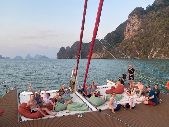 Group of people relaxing on a catamaran on the sea.