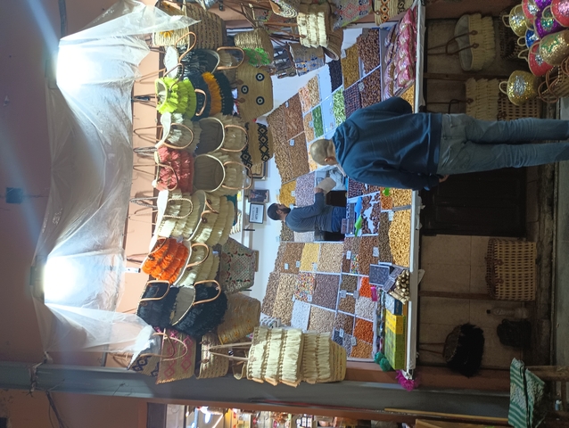 Market stall selling spices and dried goods in Morocco.