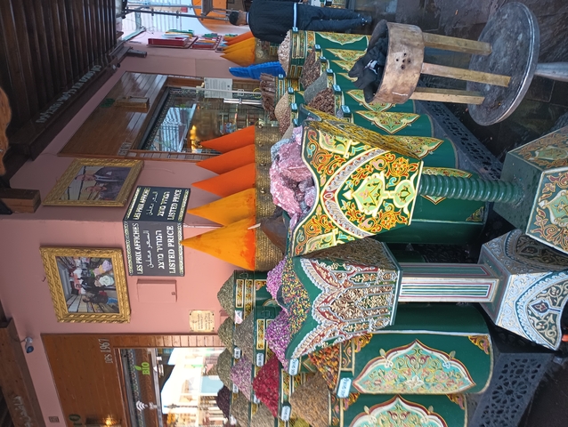       Spices and goods displayed in a Moroccan market stall.
  