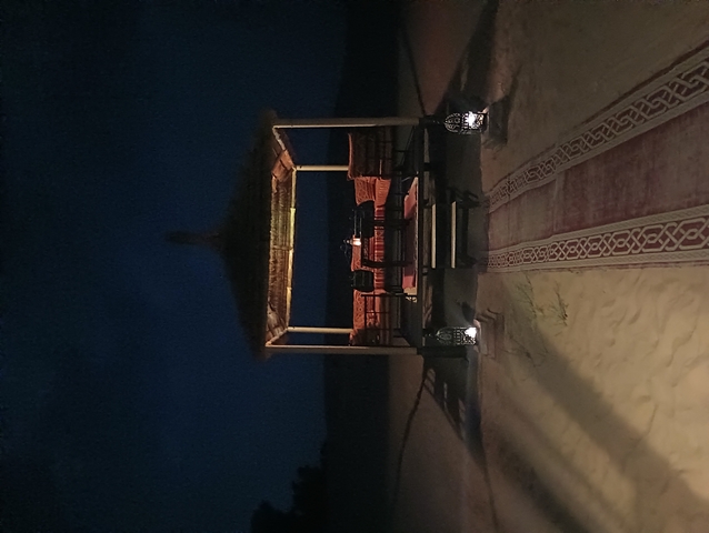 Outdoor seating area under a starry sky.