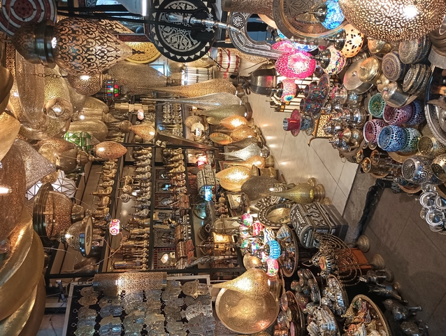 Colorful Moroccan lamps and wares displayed in a shop.