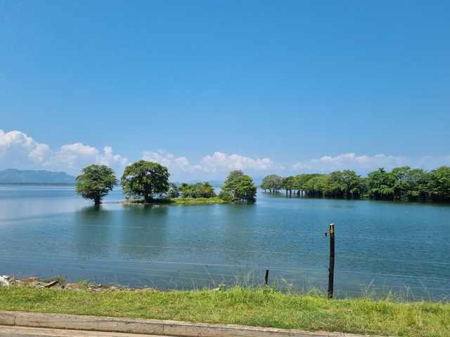       Scenic lake with small islands and distant mountains.
  