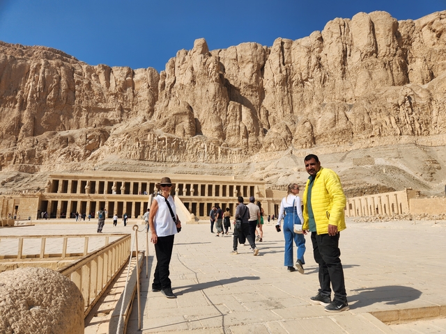 Visitors exploring the vast courtyard of Hatshepsut Temple.