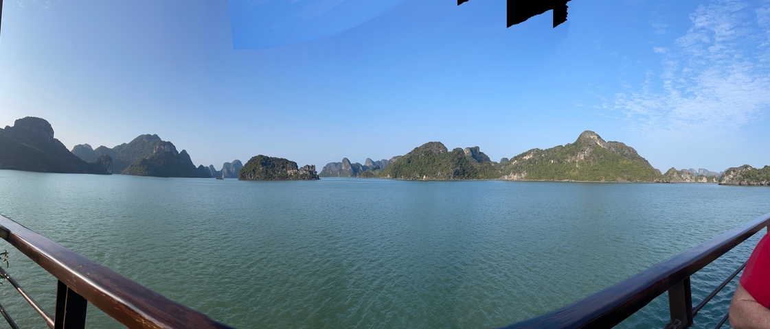       Halong Bay with scattered islands on a sunny day.
  