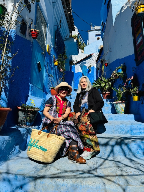 Two women in a blue-painted street.