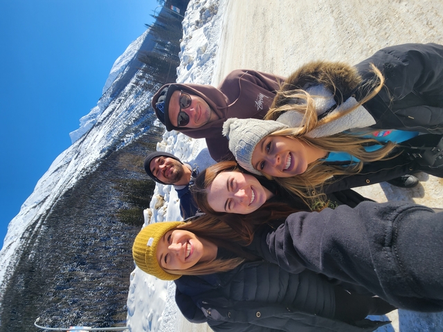 Group of people posing in a snowy landscape.