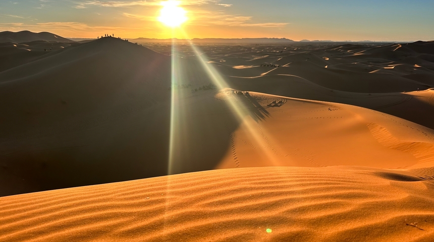 Sunset over sand dunes in the desert.