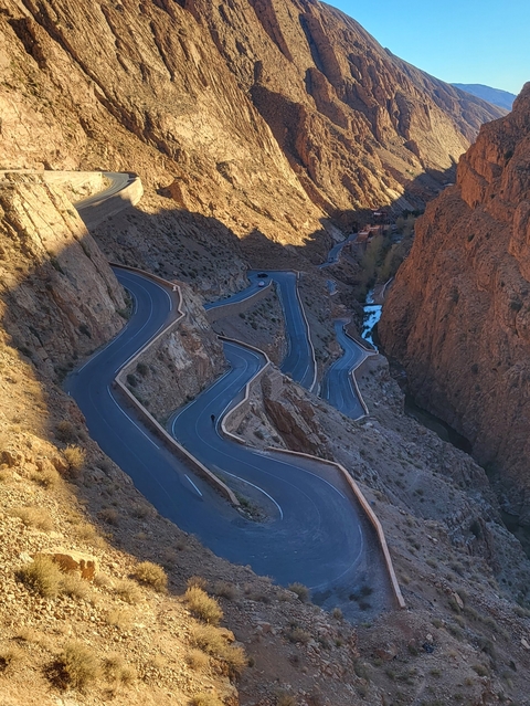       Snaking road through rugged mountain terrain.
  