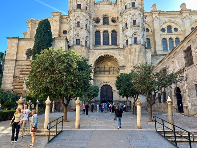 People gathering in front of a large cathedral.