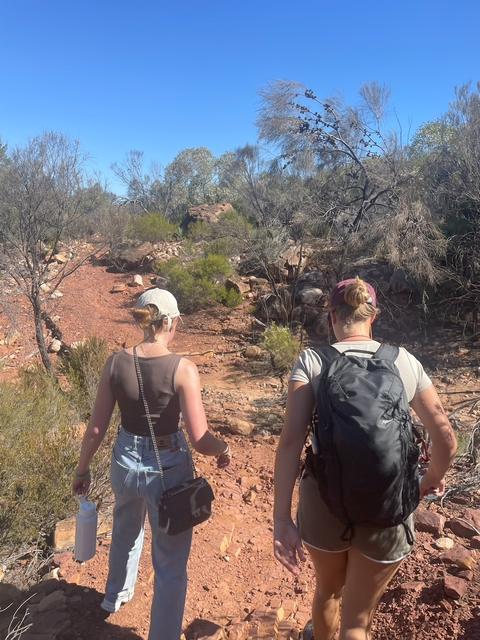 Hikers walking along a rocky trail.