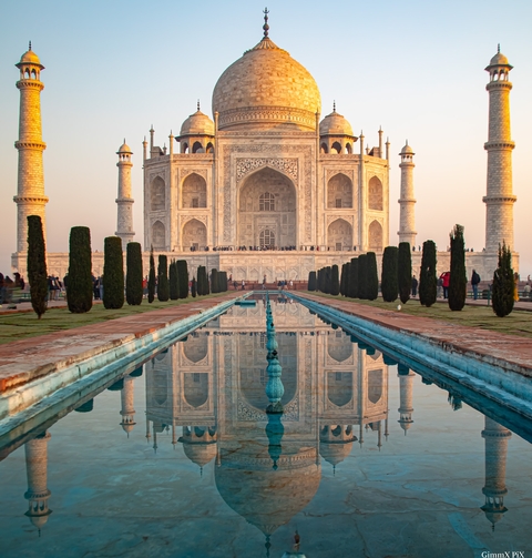 The Taj Mahal with reflections in the water.