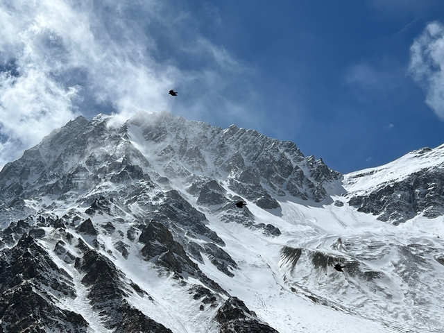 Snow-capped mountain peak against a blue sky.