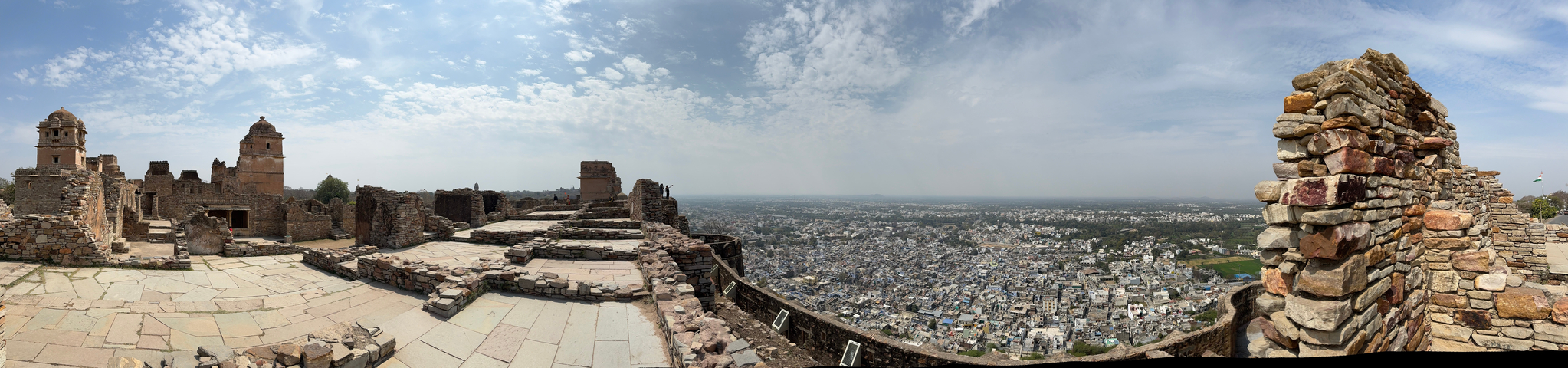 View over a cityscape with ruins in the foreground.