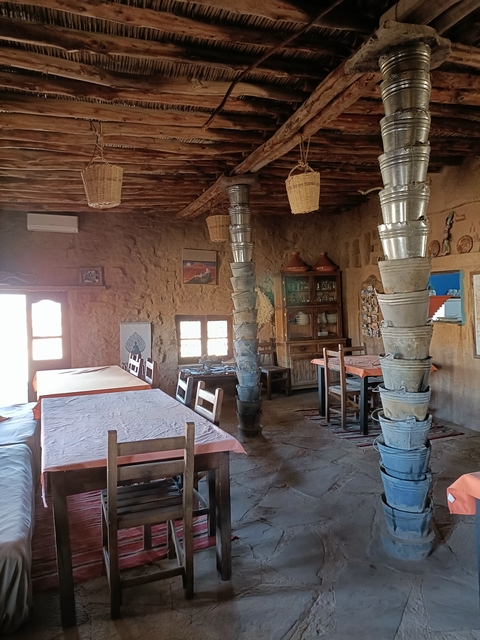       Rustic interior of a cafe or dining area with wooden furniture.
  